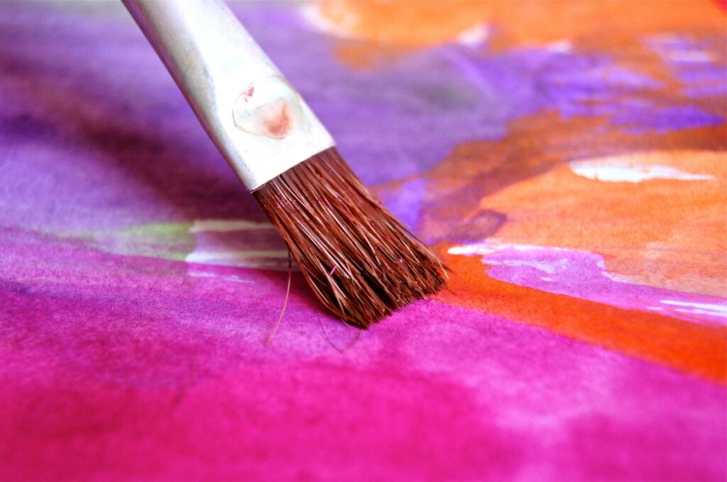 an image of a paint bush painting on a canvas by an artist who has needs for accountants in the creative industry