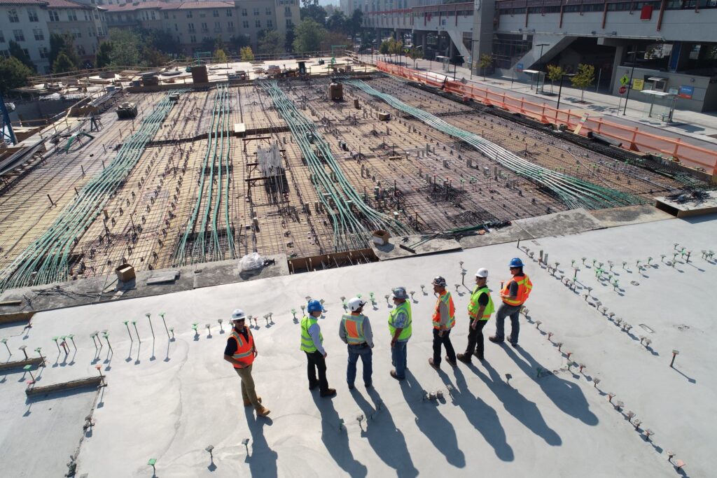 an image of construction and accountants surveying a work site