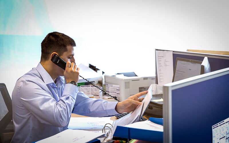 an image of a working professional at his desk requiring accountants for professional services