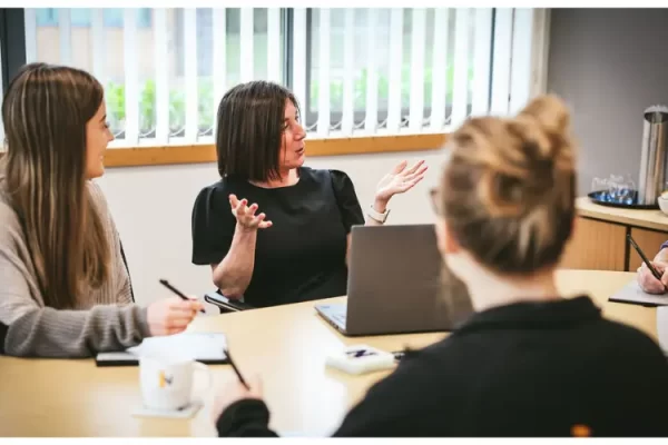 Accountants sat around a table in a meeting